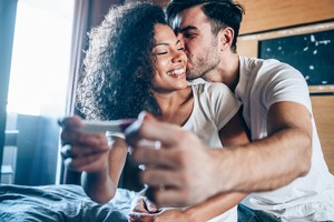 Contraception myth Shot of a happy young couple taking a pregnancy test at home