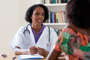 Birth control family planning contraception for women living with HIV in Nigeria female doctor talking to patient at hospital