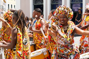 Dancer's small parade with traditional costumes celebrating with revelers the Carnival on the streets. Salvadore, Bahia, Brazil